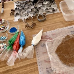 A table with a variety of supplies for making a gingerbread cookie.