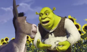 Shrek and donkey in a field of sunflowers.