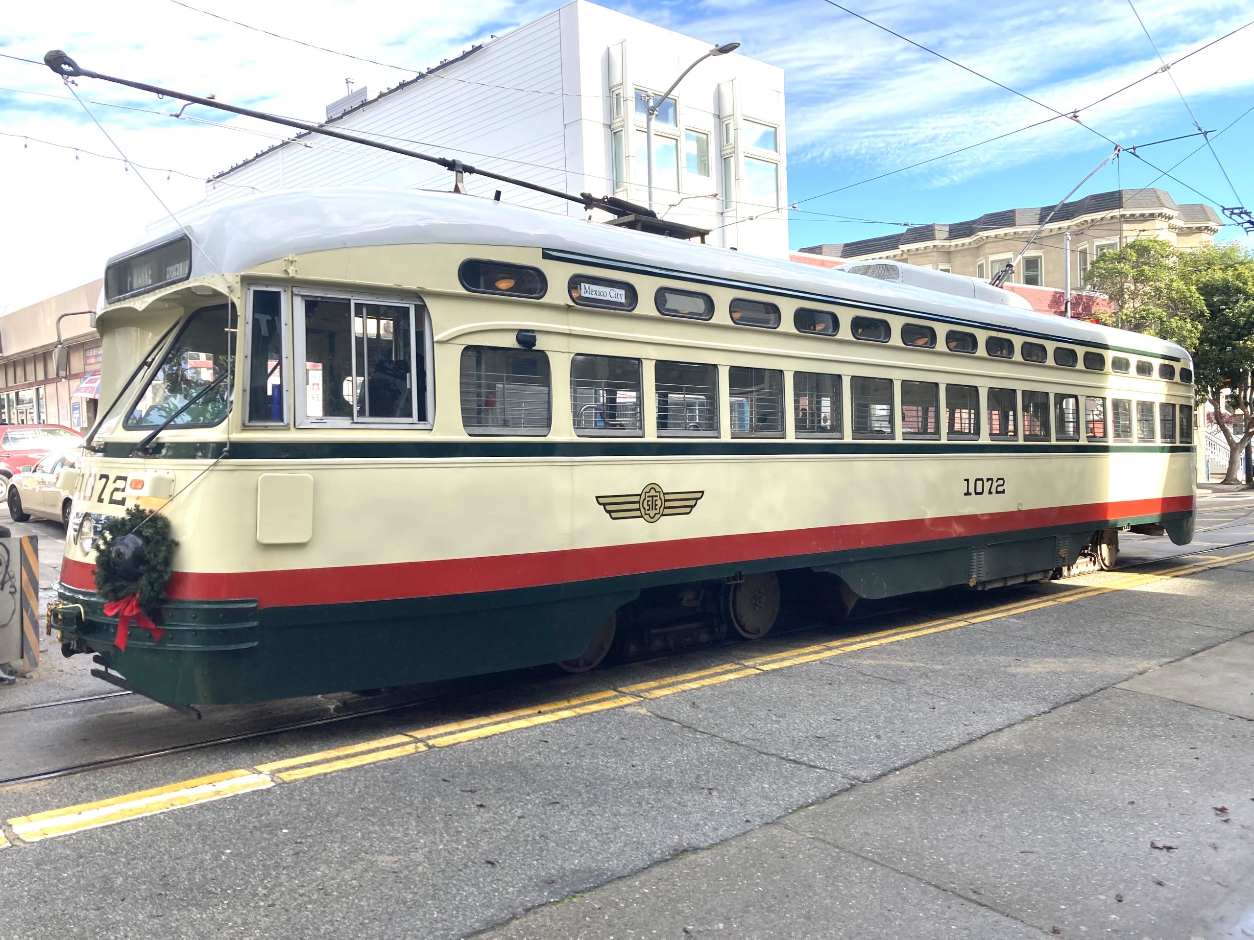 A cable car on Market Street in San Francisco on a sunny day.