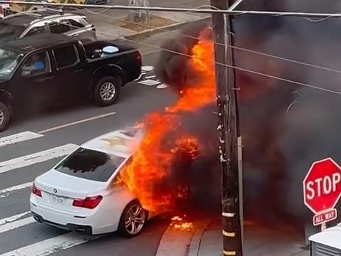 A car on fire on 24th and Hampshire streets in the Mission District