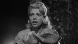 A black and white photo of a woman holding a purse.