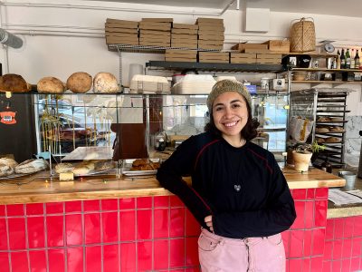 Bel Luevano standing in front of the counter in a sandwich shop.