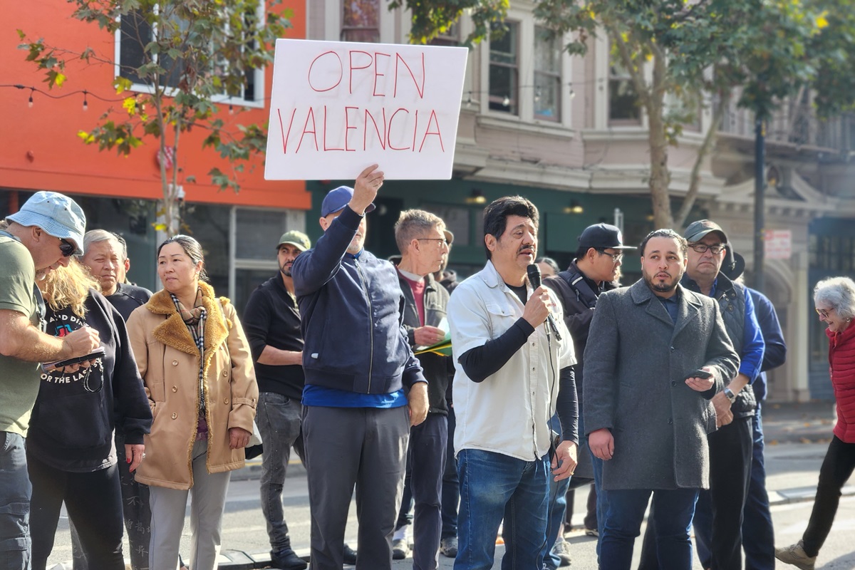 A group of people holding signs on a street.