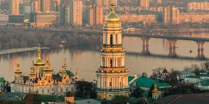 A view of a city with golden towers and a river.