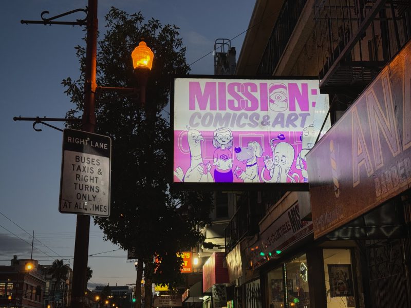 A street sign that says mission comic art.