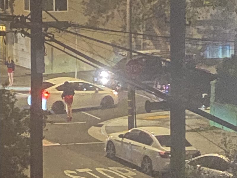 A possible sex worker soliciting a client on Shotwell, after crackdowns on Capp Street this year.