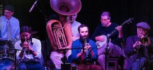 A group of musicians playing instruments on stage.