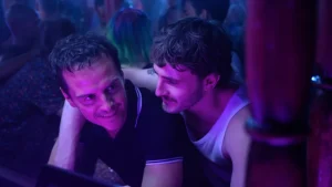 Two men in a club looking at each other.