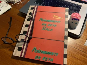 A notebook on a desk next to a pair of glasses.