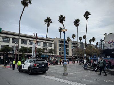 A police car enforcing a vending ban at 16th Street BART plaza