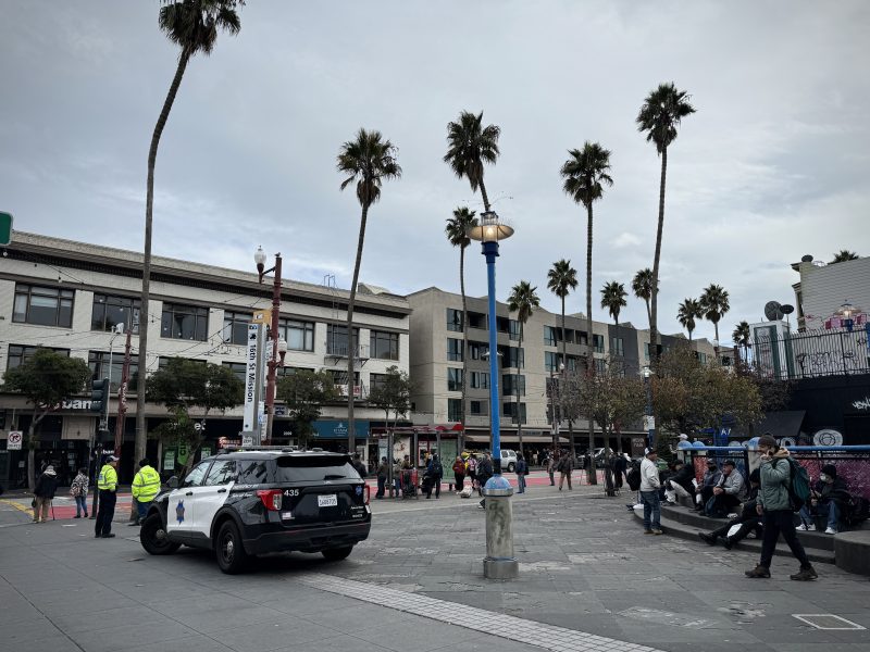 A police car enforcing a vending ban at 16th Street BART plaza