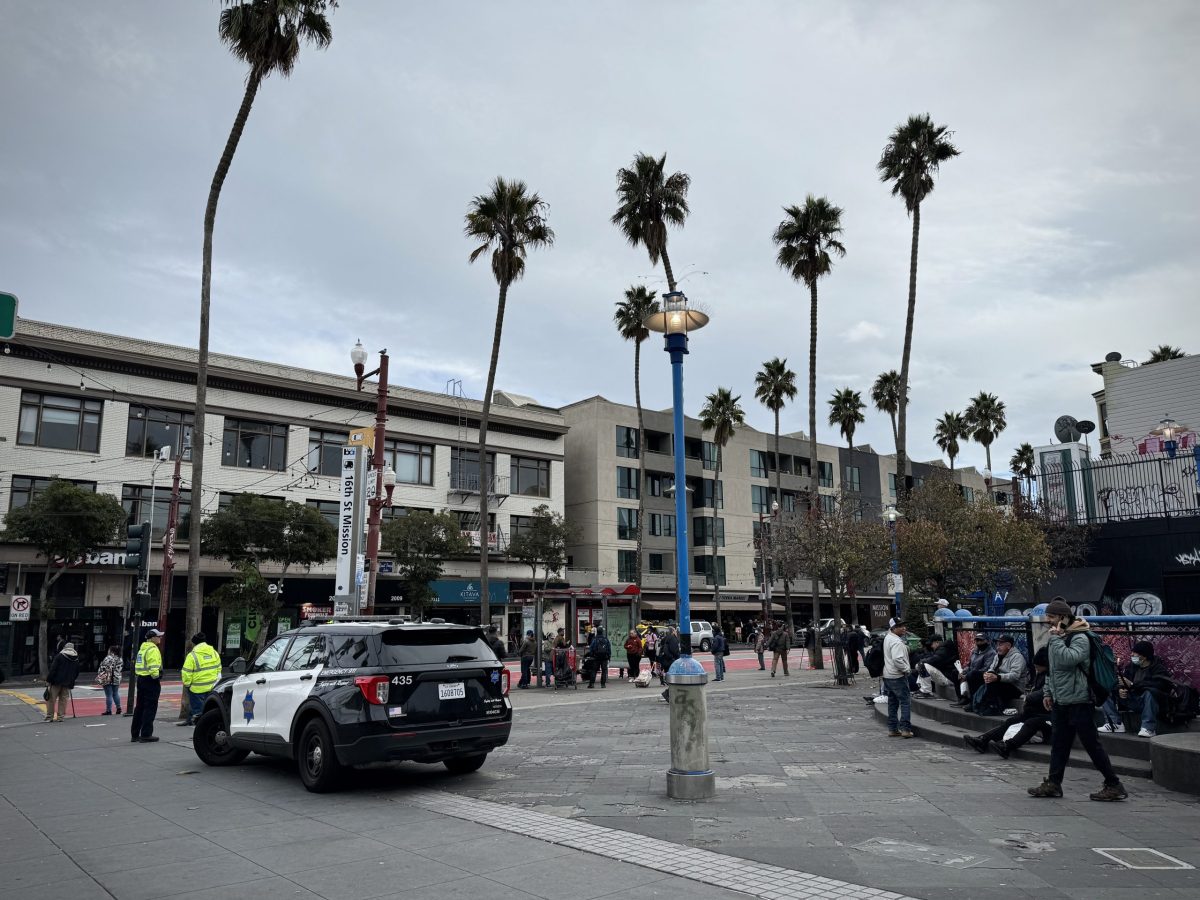 A police car enforcing a vending ban at 16th Street BART plaza