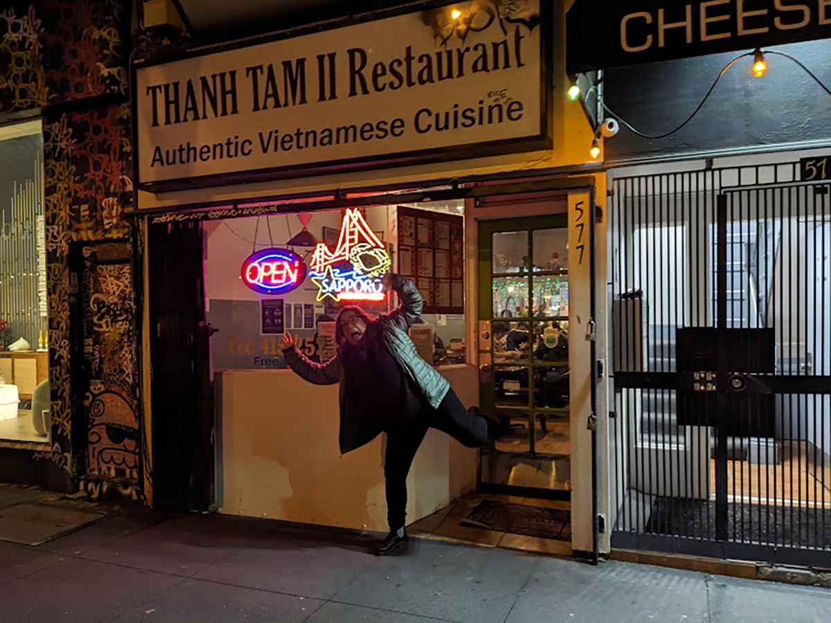 A woman in front of a restaurant.