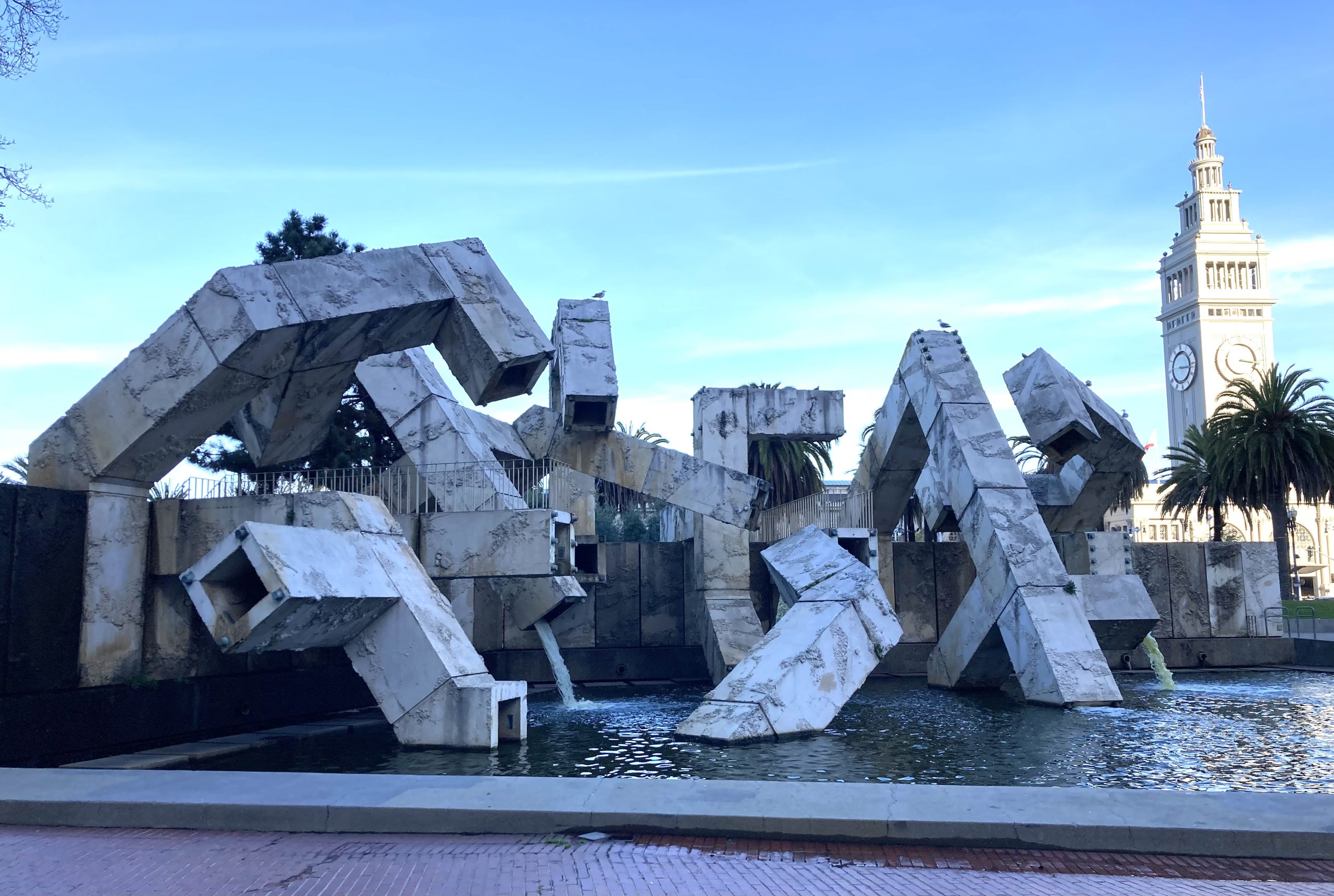 A twisty-shaped fountain at a plaza.
