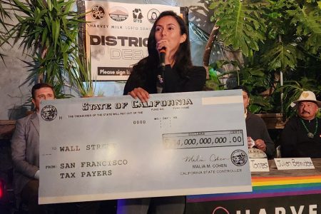 Jackie Fielder holding a big novelty check.