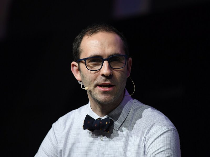 A man wearing glasses and a bow tie.