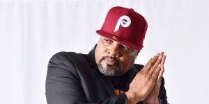 A man in a red hat is posing for a photo.