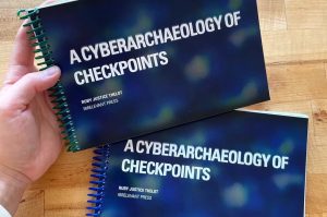 A person holding a book that says cyberbiology of checkpoints.
