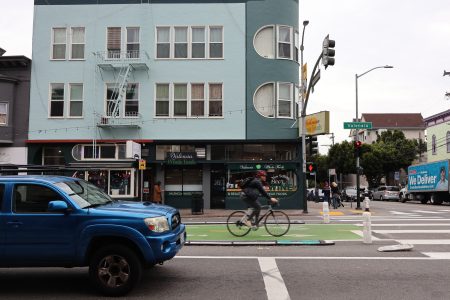 A person riding a bicycle on a street.