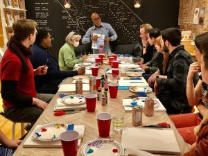 A group of people sitting around a table at a restaurant.