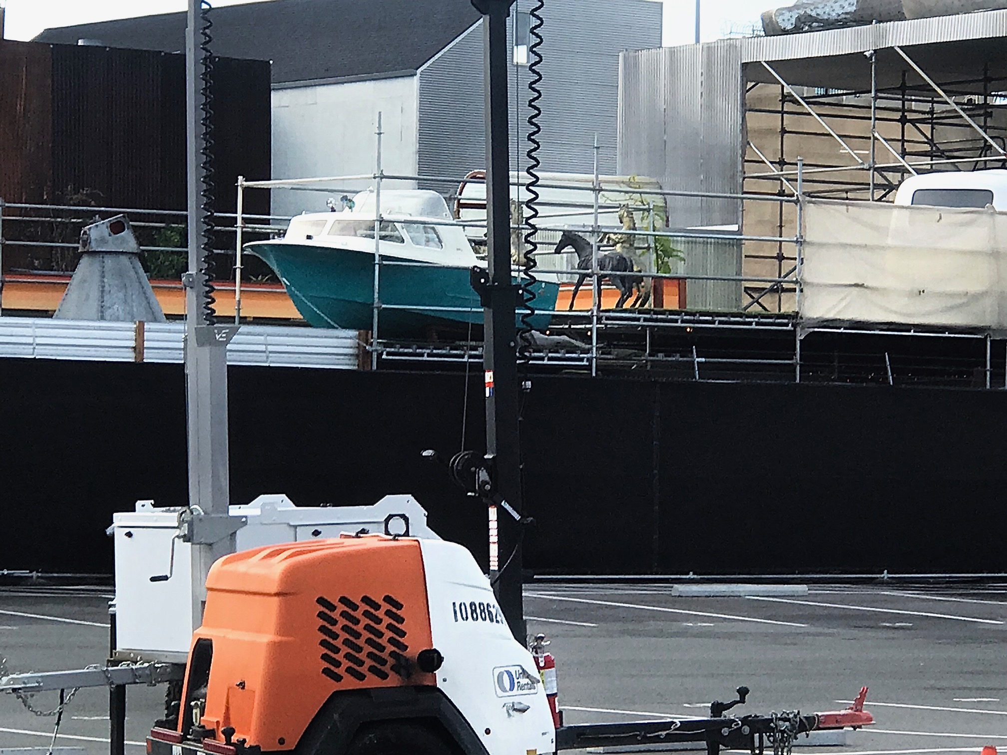 A sculpture of a hose next to a boat.