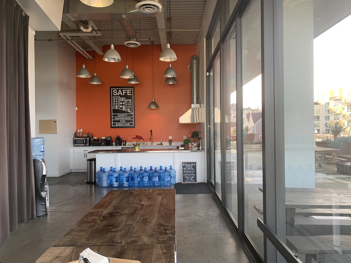 A kitchen with a table and chairs.
