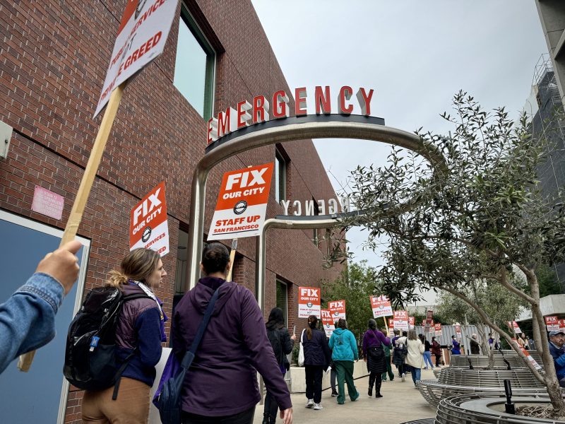 A group of people holding signs at a rally