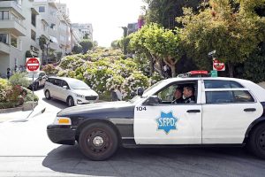 A police car driving down a street in san francisco.