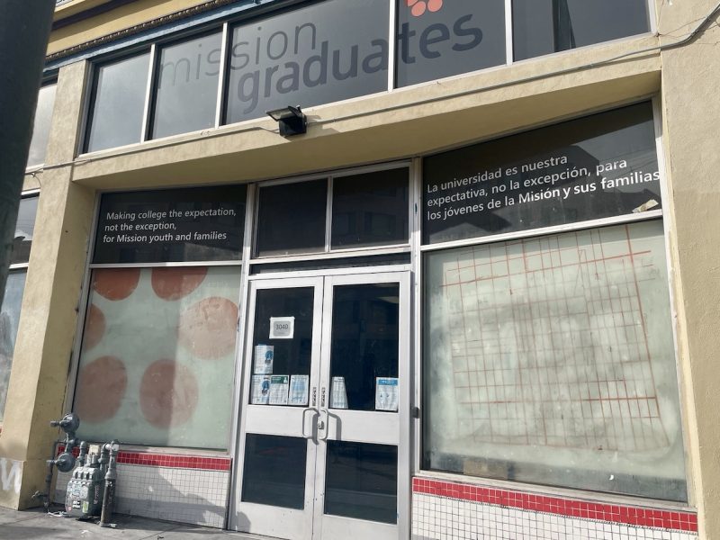Exterior view of "mission graduates" building in Everett with educational motto displayed on the window.