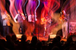 Jazz musicians performing on stage with motion blur effect.