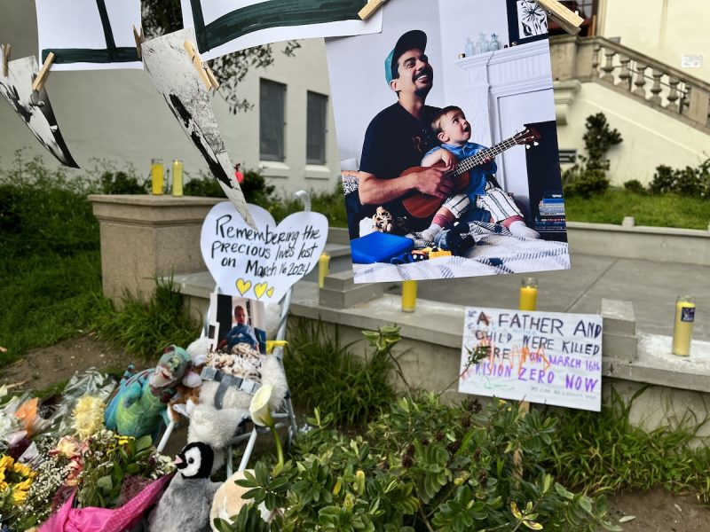 Memorial tribute with photographs and toys commemorating a father and child.