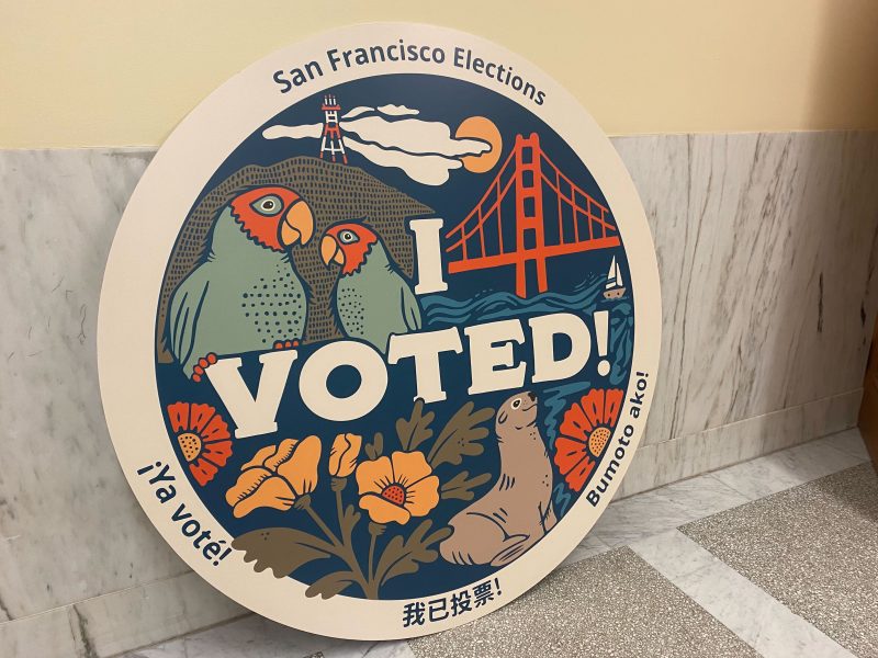 A giant "I voted" sign at San Francisco City Hall with parrots, poppies, the Golden Gate Bridge, seals and more