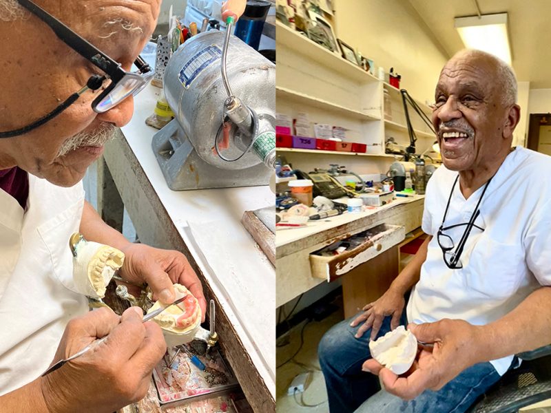 A smiling dental technician working on prostheses in a laboratory setting.