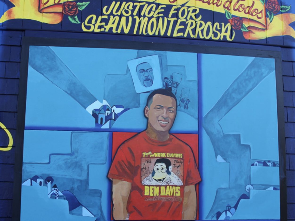 A mural dedicated to sean monterrosa featuring his portrait, with messages calling for justice and imagery representing peace and remembrance.