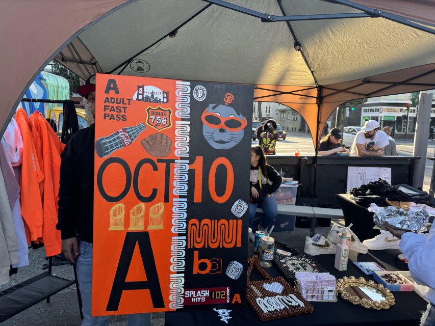 A stall displaying a large orange poster.