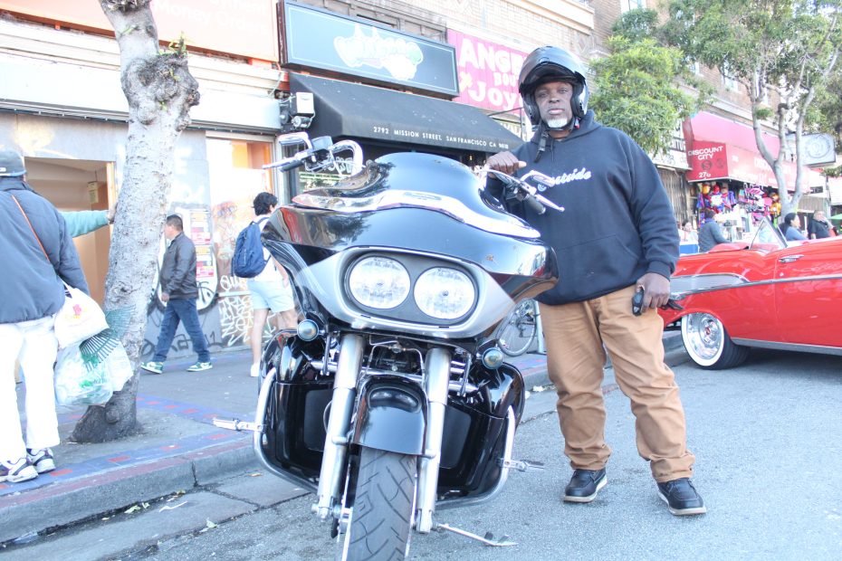 Dereck Cooper poses with his Harley Davidson during the Selena lowrider tribute