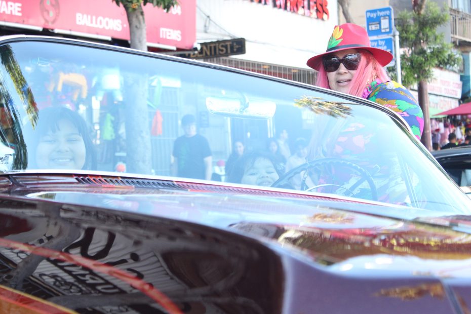 Valeria Villareal poses with her lowrider and her two children during the Selena lowrider tribute