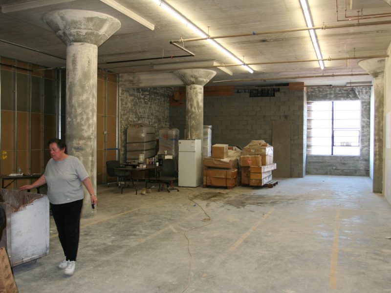 Landlord Vera Cort walks by the 1890 Bryan during construction