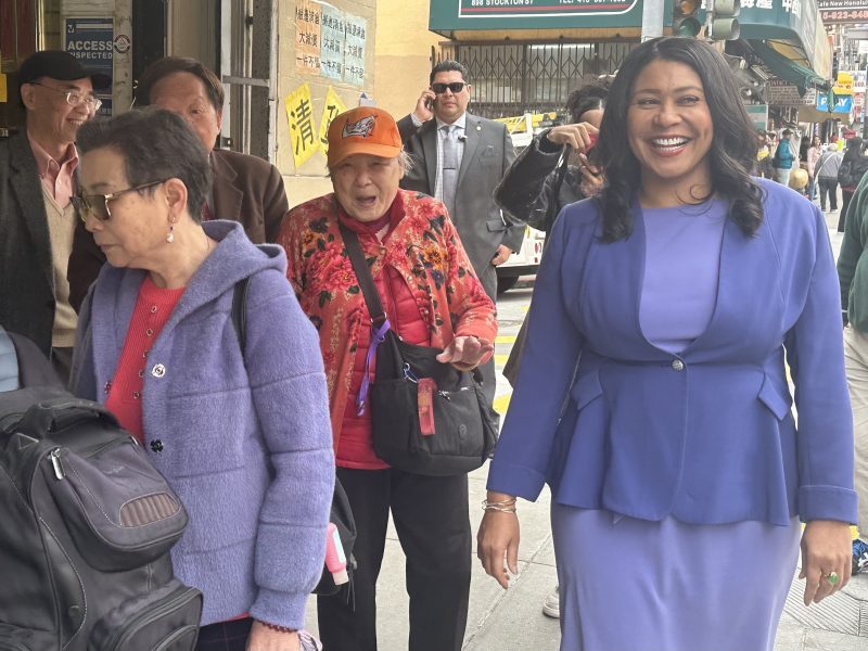 Mayor London Breed walking alongside supporters in Chinatown