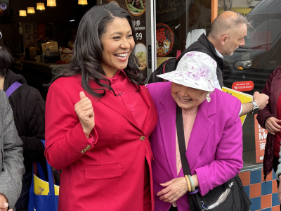 Mayor London Breed, smiling, standing next to Mrs. Wong,