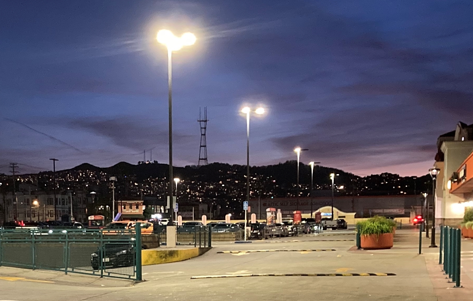 A parking lot at night with lights on.