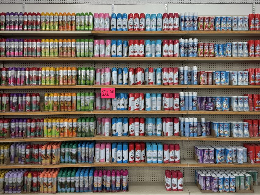 Aisle in a store displaying a variety of colorful air fresheners neatly arranged on shelves