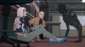 Two animated characters, a young man and woman, sit on the floor looking at a robot in a cluttered office setting.