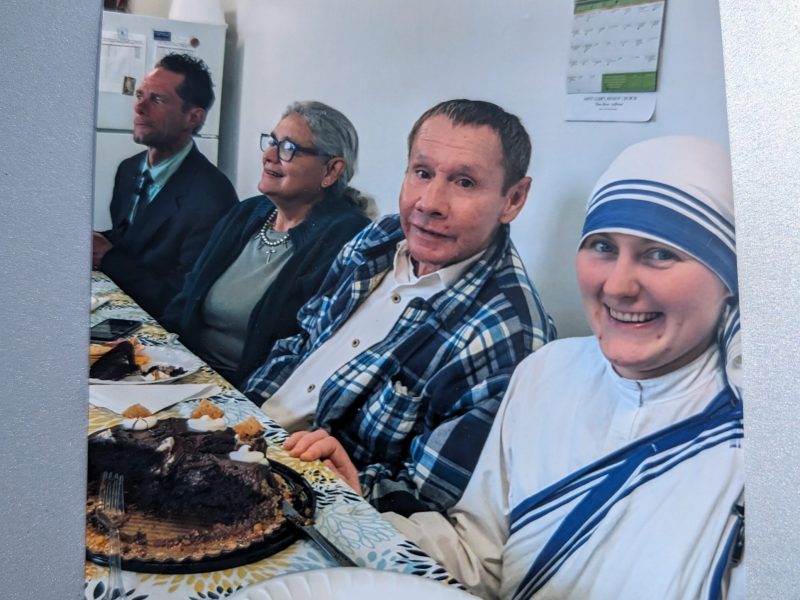 Gerald Gleeson poses for a picture while he has a meal with friends.
