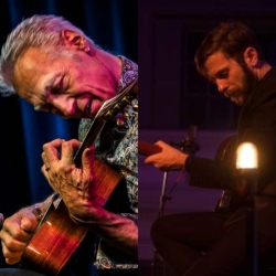 Two musicians playing guitars. The older man on the left has white hair and colorful lighting, while the younger man on the right has dark hair and is under dim lighting.