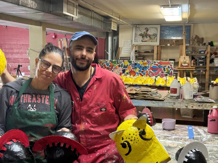 Daniel Iturralde and Gina Moreno pose for a picture inside of the studio where they have been making head-pieces for this Sunday's carnaval parade.