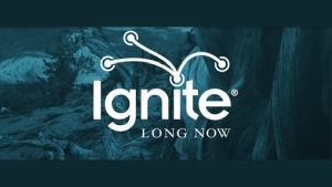 The image shows the logo for Ignite Long Now, featuring the word "Ignite" with a stylized spark design above it and "LONG NOW" written below, set against a nature-themed background.
