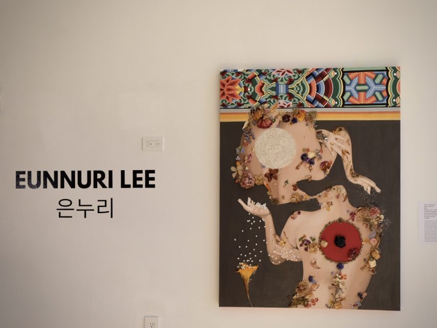 A framed abstract artwork featuring a floral and geometric design is displayed on a wall. The text "EUNNURI LEE" and "은누리" is visible next to the artwork.