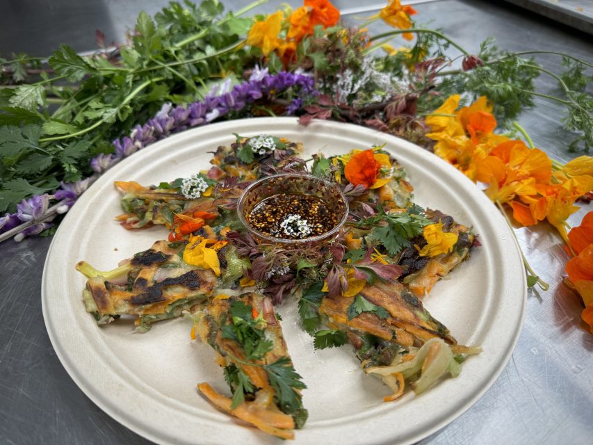 a Korean veggie pancake garnished by flowers