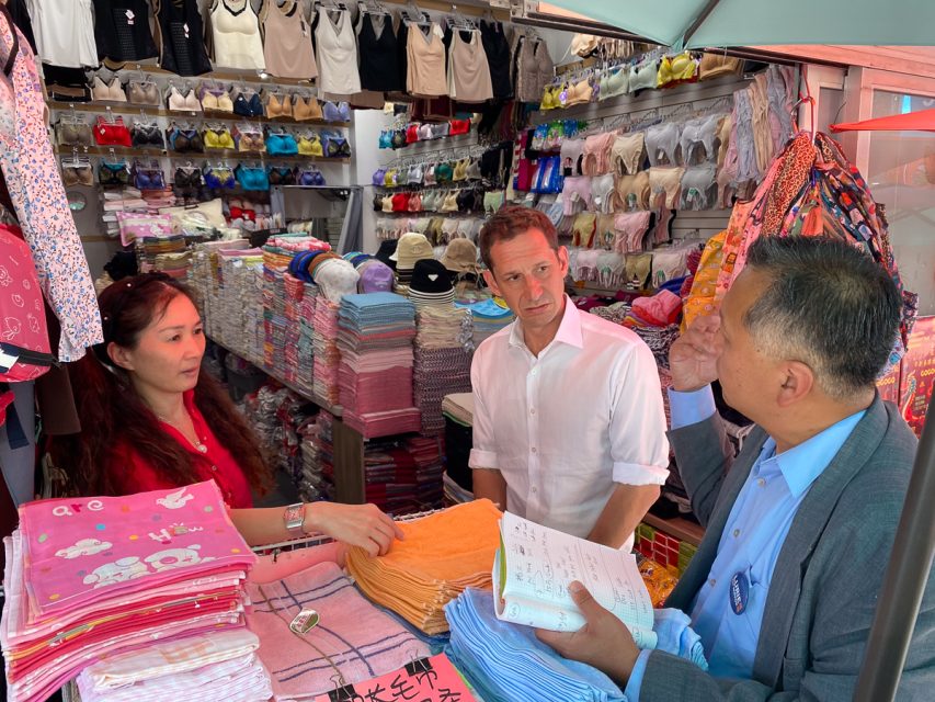 Kit Lam helps Daniel Lurie interpret when talking with Diane Tan.